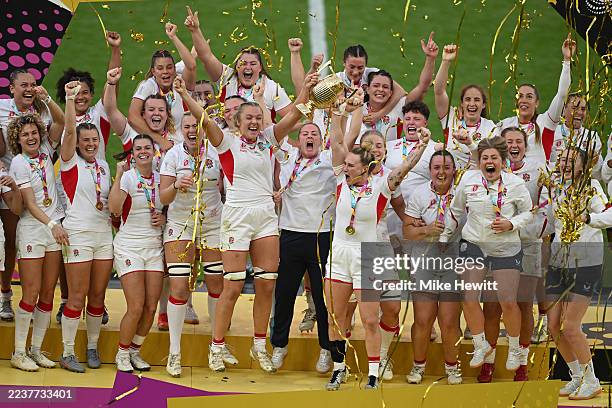 Zoe Aldcroft and Megan Jones of England lift the Women's Rugby World Cup trophy following victory in the Women's Rugby World Cup 2025 Final match...