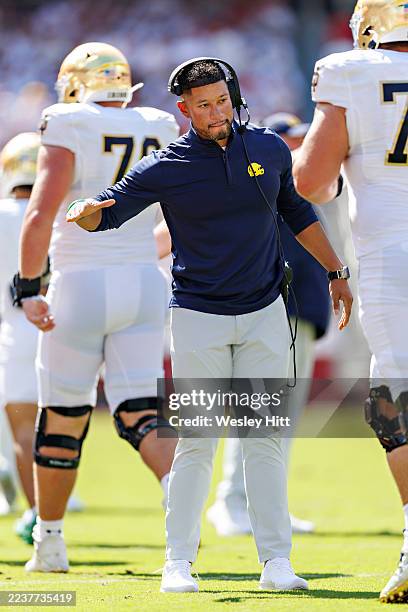 Head Coach Marcus Freeman of the Notre Dame Fighting Irish greets players as they come off the field in the first half during a game against the...