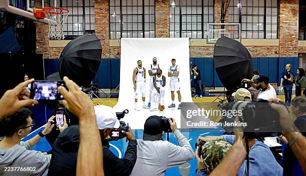 Klay Thompson, Anthony Davis, Kyrie Irving and Cooper Flagg of the Dallas Mavericks pose for photographers during Dallas Mavericks media day at...