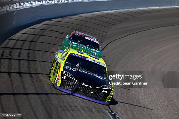 Brandon Jones, driver of the Menards/Spectracide Toyota, and Ryan Ellis, driver of the Tablo Chevrolet, race Hardscape Contractors Chevrolet, during...