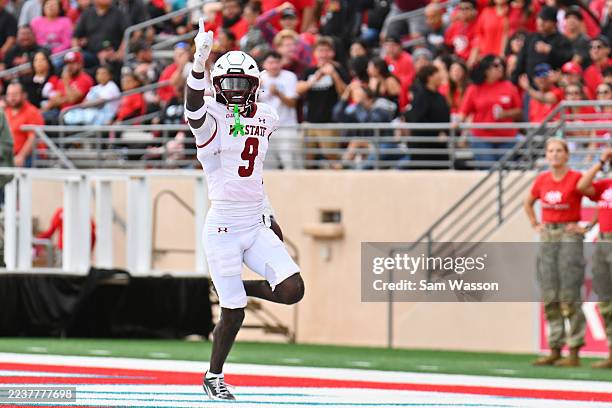 Safety Bernock Iya of the New Mexico State Aggies celebrates after returning a fumble for a touchdown against the New Mexico Lobos during the first...