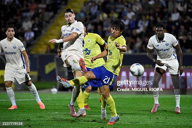 Porto's Spanish forward Borja Sainz fights for the ball with Arouca's Japanese midfielder Taichi Fukui during the Portuguese League football match...