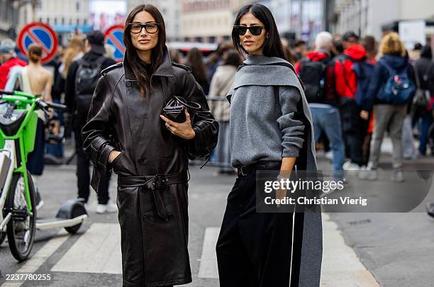 Giorgia Tordini wears brown leather coat, pants & Gilda Ambrosio wears grey jumper, black pants outside Ferragamo during the Milan Fashion Week...