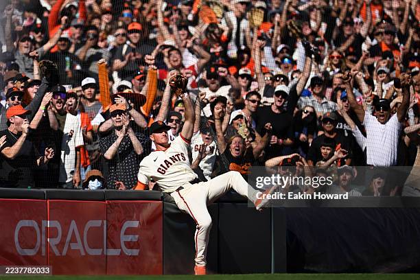 Matt Chapman of the San Francisco Giants celebrates the game winning out after catching a foul ball hit by the Colorado Rockies in the ninth inning...