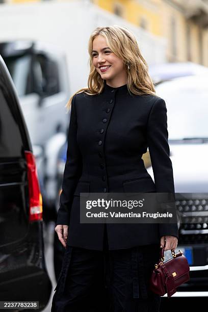 Emma Brooks wears a black corean styled jacket, black cargo trousers and a bordeaux leather Dolce & Gabbana bag outside Dolce & Gabbana show during...