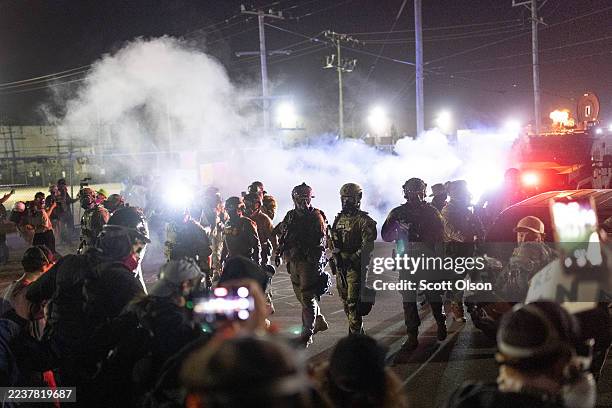 Federal law enforcement agents attack demonstrators protesting outside of an immigrant processing center with a barrage of tear gas and pepper balls...