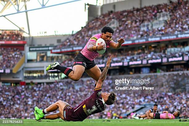 Paul Alamoti of the Panthers beats Reece Walsh of the Broncos before scoring a try during the NRL Preliminary Final match between Brisbane Broncos...
