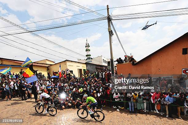 Isaac Del Toro and Team Mexico and Tadej Pogacar and Team Slovenia compete in the breakaway climbing the Mur de Kigali cobblestones sector during the...