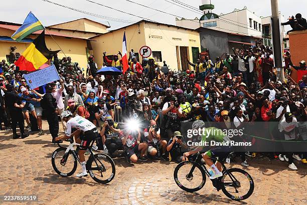 Isaac Del Toro and Team Mexico and Tadej Pogacar and Team Slovenia compete in the breakaway climbing the Mur de Kigali cobblestones sector during the...