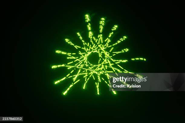laser light luminous spirograph pattern—a complex web of perfect geometric curves and loops. - laser pointer stock pictures, royalty-free photos & images