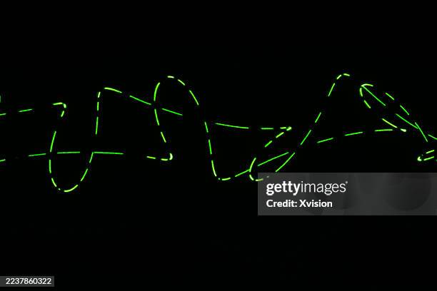 laser light luminous spirograph pattern—a complex web of perfect geometric curves and loops. - laser pointer stock pictures, royalty-free photos & images