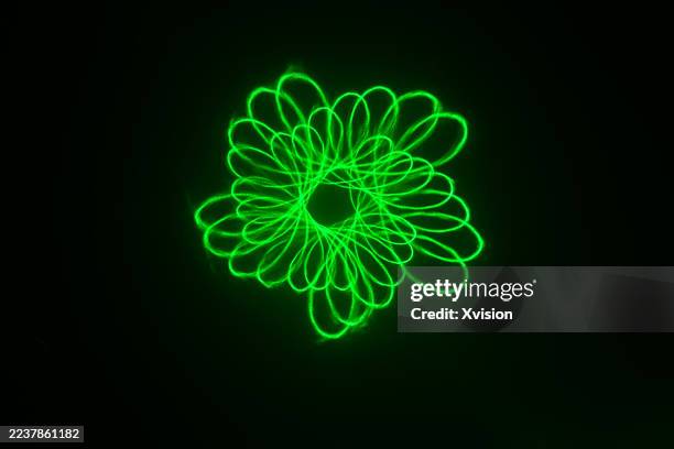 laser light luminous spirograph pattern—a complex web of perfect geometric curves and loops. - laser pointer stock pictures, royalty-free photos & images