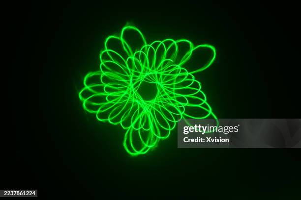 laser light luminous spirograph pattern—a complex web of perfect geometric curves and loops. - laser pointer stock pictures, royalty-free photos & images