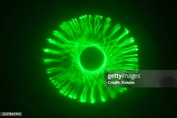 laser light luminous spirograph pattern—a complex web of perfect geometric curves and loops. - laser pointer stock pictures, royalty-free photos & images