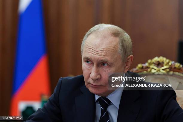 In this pool photograph distributed by the Russian state agency Sputnik, Russia's President Vladimir Putin looks on as he meets Russia's Deputy Prime...