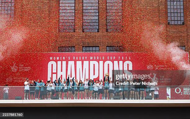 Zoe Aldcroft of England Red Roses lifts the Women's World Cup trophy as she celebrates with teammates during the England Red Roses World Cup victory...