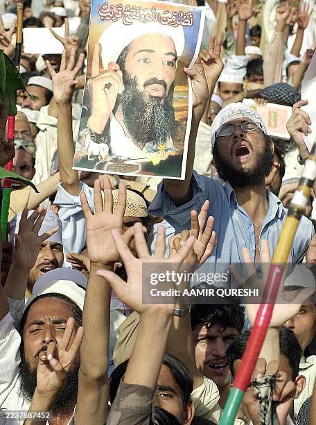 Activist of the Sunni muslim extremist group Sipha-i-Sahaba Pakistan shouts anti-US slogans carrying a portrate Osama bin Laden during a protest in...