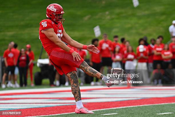 Punter Daniel Hughes of the New Mexico Lobos punts against the New Mexico State Aggies during the first half of a game at University Stadium on...