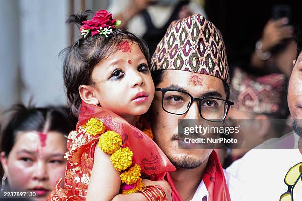 Newly appointed Royal Living Goddess Aryatara Shakya, 2 1/2 years old, is carried from her private house towards the historic Kumari Ghar at...