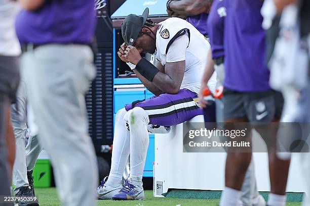 Lamar Jackson of the Baltimore Ravens looks on from the bench during the fourth quarter against the Kansas City Chiefs at Arrowhead Stadium on...