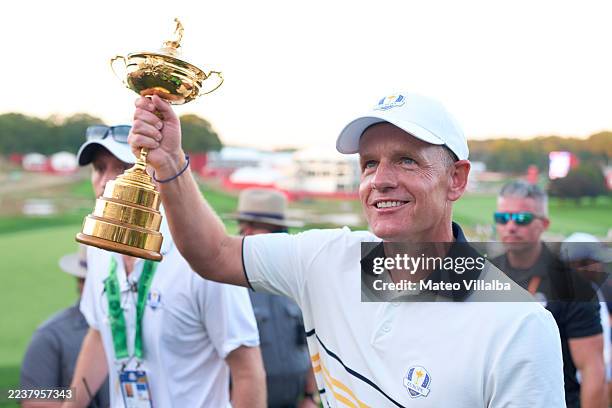 Captain Luke Donald of Team Europe raises the Ryder Cup trophy during the trophy ceremony after the singles matches, during the Sunday singles...