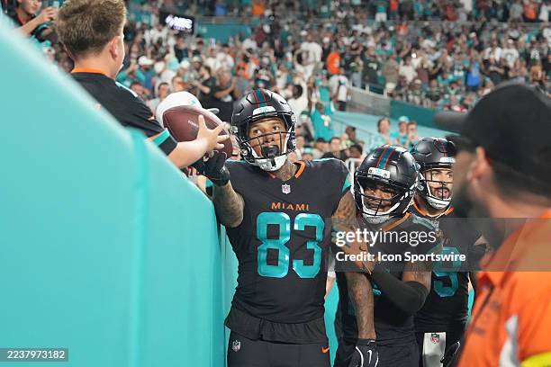 Miami Dolphins tight end Darren Waller hands a kid the ball after his second touchdown during the game between the New York Jets and the Miami...