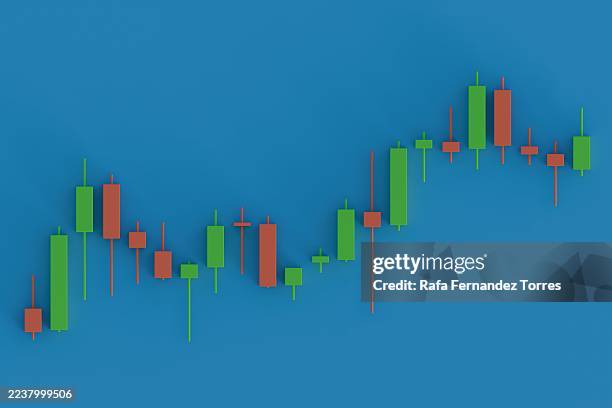 green and red candlestick chart on blue background - kerzenleuchter stock-fotos und bilder