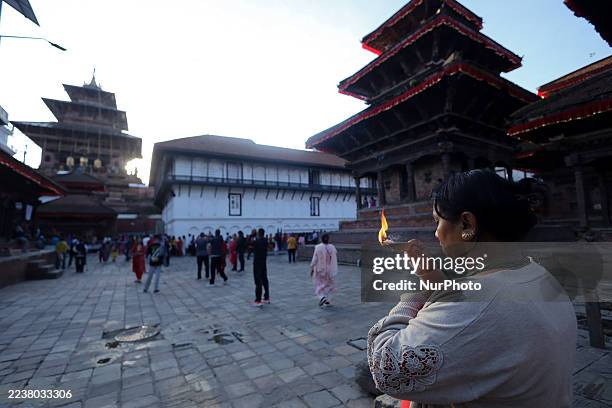 Nepali Hindu devotee offers oil-fed lamps to the Taleju Bhawani on the ninth day of the fortnightly festival of Dashain at Kathmandu Durbar Square in...