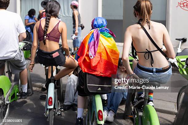 youth people sitting on city bike before the gay pride parade in paris - electric bicycle stock pictures, royalty-free photos & images