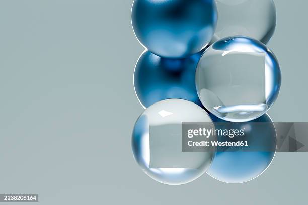 abstract floating blue glass marbles on a minimal background - blue glass marble stock illustrations