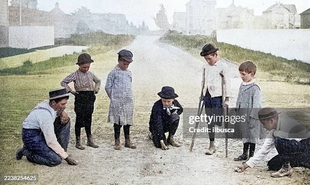 antique photograph: children playing in the street - amputee stock illustrations