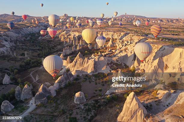 Hot air balloons fly over the fairy chimneys and valleys of Cappadocia, a UNESCO World Heritage Site, on October 02, 2025 in Nevsehir, Turkiye. Hot...