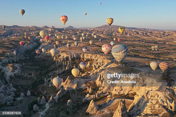 Hot air balloons fly over the fairy chimneys and valleys of Cappadocia, a UNESCO World Heritage Site, on October 02, 2025 in Nevsehir, Turkiye. Hot...