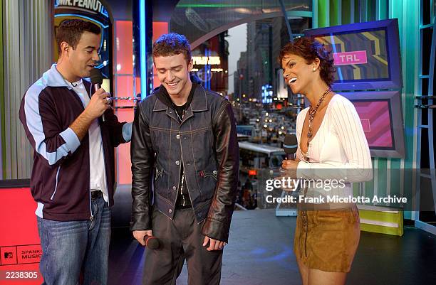 Carson Daly introduces surprise guest Halle Berry to Justin Timberlake on MTV's Spankin New Music Week on TRL at the MTV Times Square Studios in New...