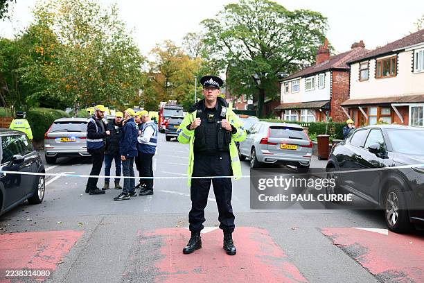 Police officer stands on duty at a cordon near Heaton Park Hebrew Congregation synagogue in Crumpsall, north Manchester, on October 2 following...