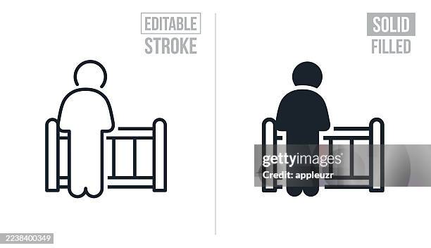 mother looking down into baby's crib - editable stroke and solid icons - mum cot stock illustrations