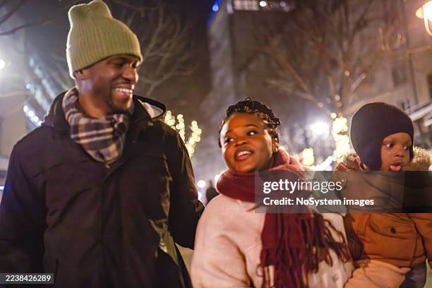 family stroll evening lights - atmospheric mood stock pictures, royalty-free photos & images