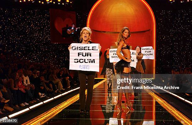 Protesters from Peta disrupt the 2002 Victoria's Secret Fashion Show while model Gisele Bundchen walks the runway at the Lexington Avenue Armory in...