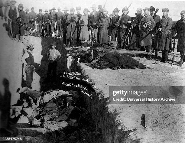 The Wounded Knee Massacre, also known as the Battle of Wounded Knee, was Burial of the dead after the massacre of Wounded Knee. U.S. Soldiers putting...