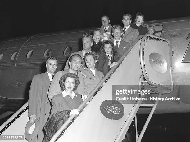 Members of the Hollywood Committee for the First Amendment disembarking plane in Los Angeles, California. The members are Marsha Hunt, Shepperd...