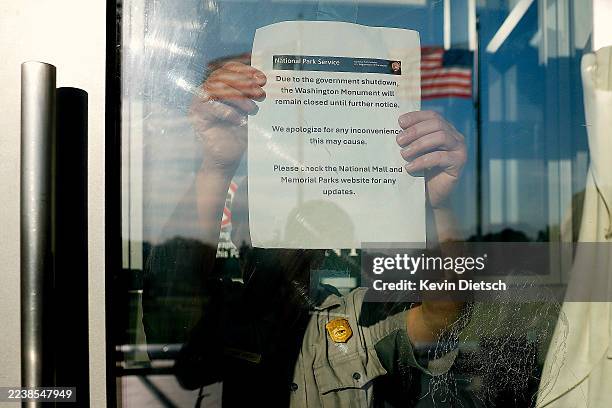 Member of the U.S. Park Service puts up a closed sign at the Washington Monument on October 01, 2025 in Washington, DC. The U.S. Federal government...