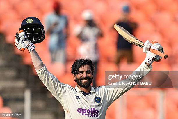 India's Ravindra Jadeja celebrates after scoring a century during the second day of the first Test cricket match between India and the West Indies at...