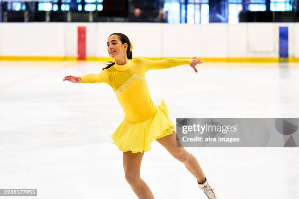 young girl figure skating performing on ice rink - ice skater stock pictures, royalty-free photos & images