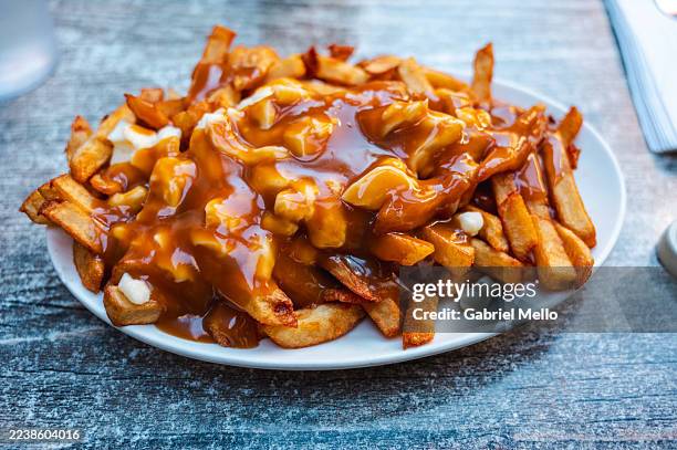 classic poutine close up - savoury sauce stock pictures, royalty-free photos & images
