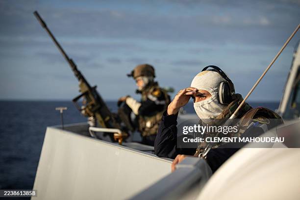 French Navy officers stand by a 12.6 mm submachine gun, while searching for hostile drones, aboard the French Navy FREMM multipurpose frigate "La...