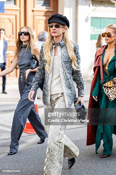 Guest wears baker boy hat, snake print, pants outside Gabriela Hearst during the Womenswear Spring Summer 2026 as part of Paris Fashion Week on...