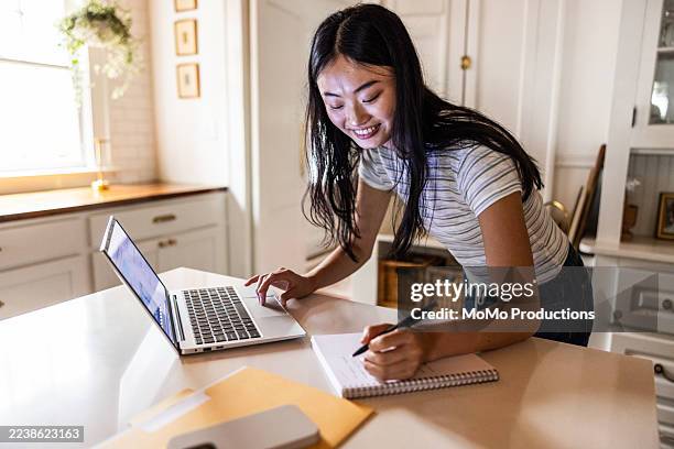 teenage girl using laptop at home - east asian ethnicity stock pictures, royalty-free photos & images