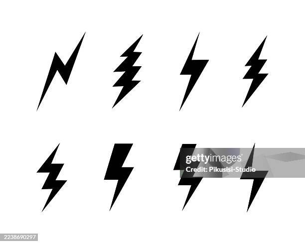 set of black lightning bolt icons. flash charge, voltage, thunder and lightning strike symbols. - electric shock stock illustrations