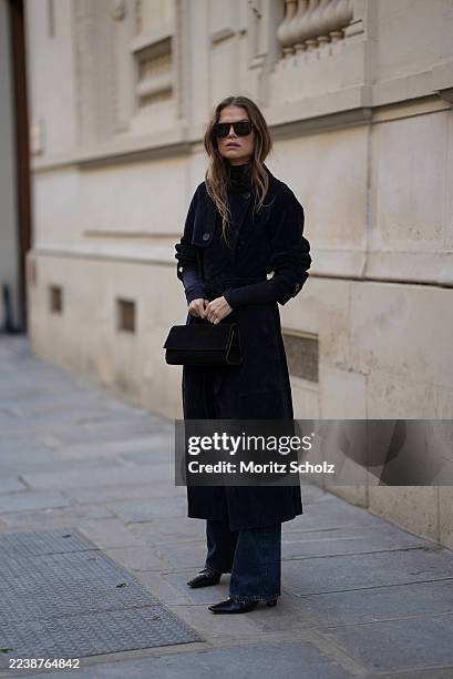 Lu Hough is seen wearing a navy blue, slim fit, long-sleeved, turtleneck sweater made of merino wool by Cos; a navy blue, long and straight-cut...
