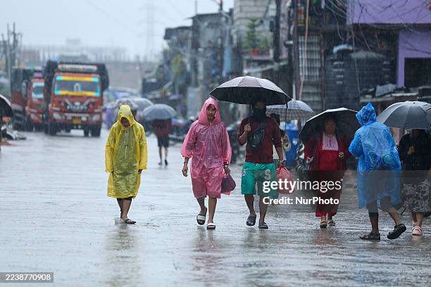 Displaced Nepali residents living along the riverbanks in the Kathmandu Valley carry their essentials and move to higher grounds after their houses...